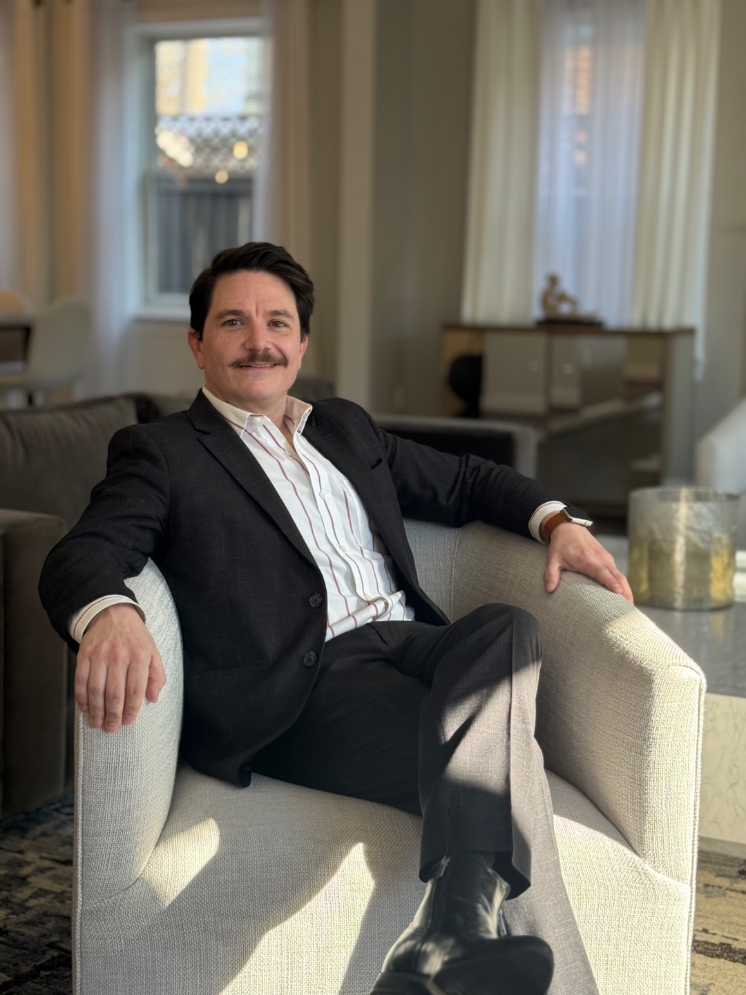 Juan M. Martinez Nadal, luxury real estate advisor, seated in an elegant living room